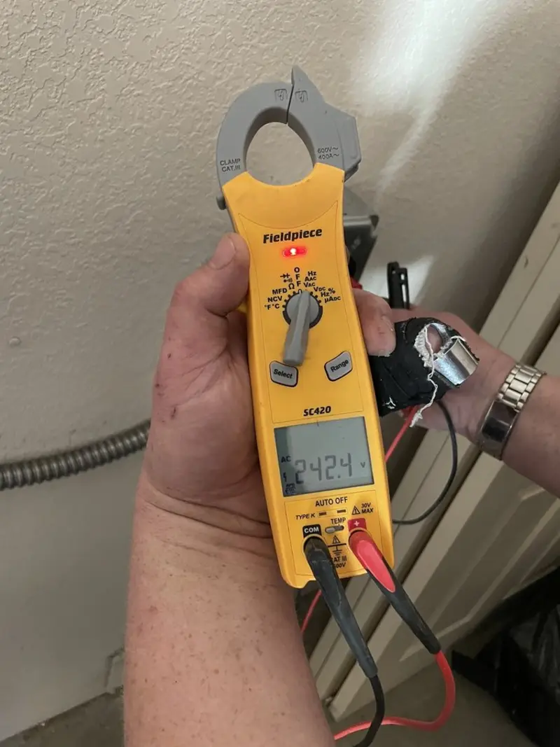 Voltage testing with clamp meter during Recessed Lighting Installation in Northville